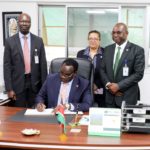 Kenya’s Cabinet Secretary for Education Hon Julius Migos Ogamba signing the visitors book when he visited icipe. He is flanked by the Director General Dr Abdou Tenkouano (Right), The Director, Human Resources & Protocol, Mrs Veronica Waiyaki (Centre behind the Minister) and Dr Julius Ecuru, The RCU Manager (Left)