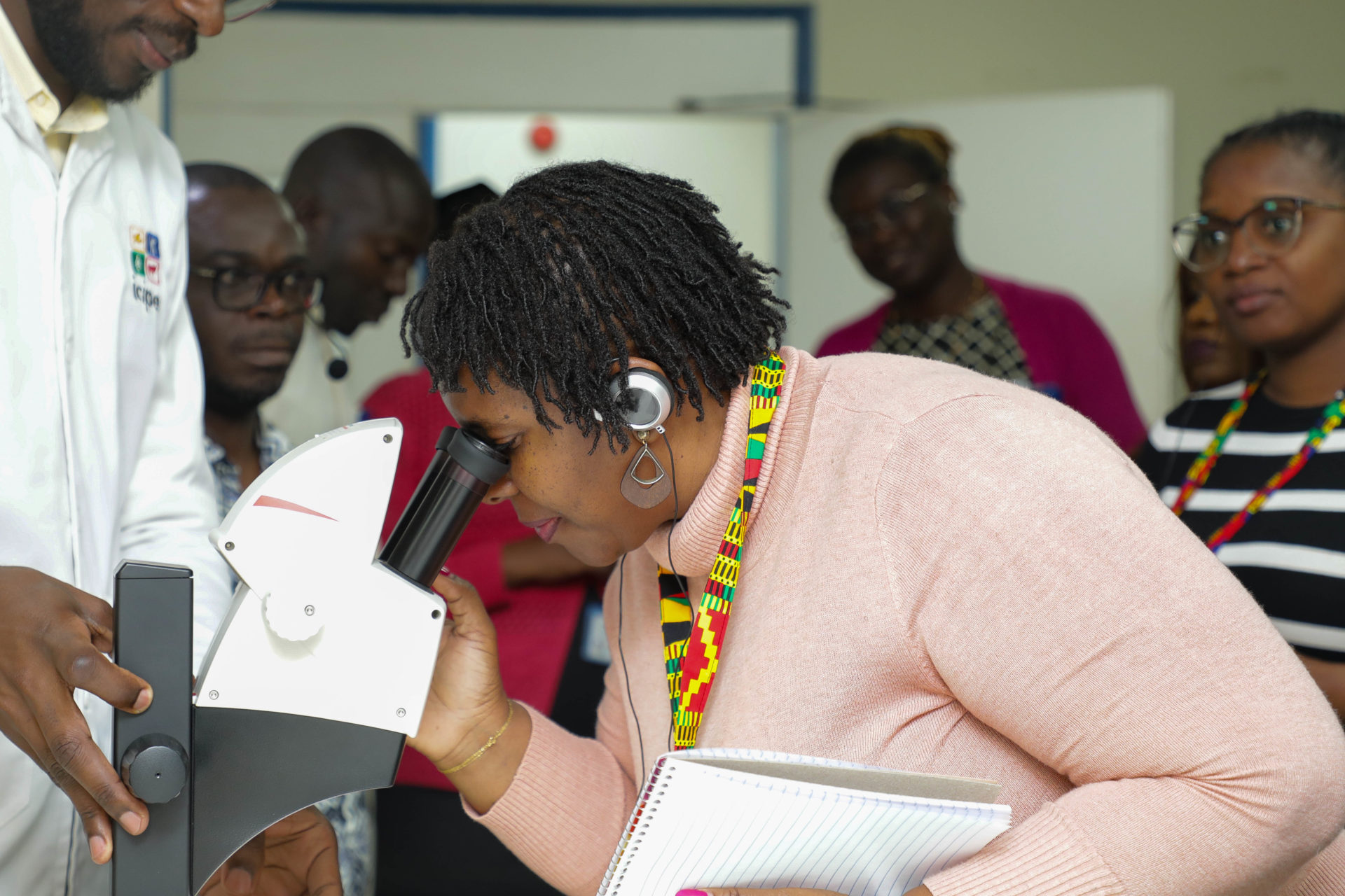 Prof Lubacha Zilhao, Director of the Office of Evaluation and Quality at the University Púnguè  (UNIPUNGUE) and coordinator of the MozSkills project  looks through a microscope at the Arthropod Pathology Unit